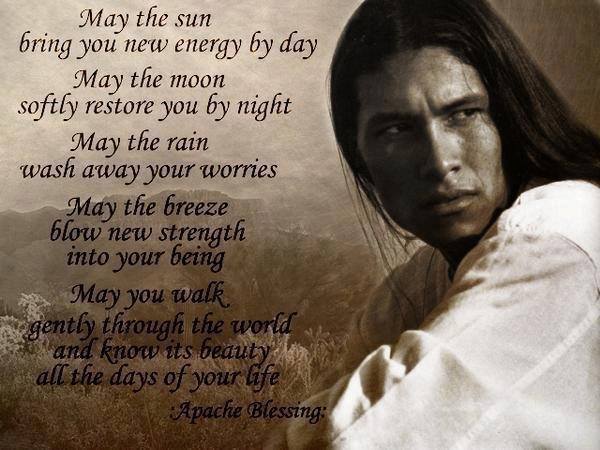 A young handsome Native American man looks at us with the text of the Apache Blessing to his side.