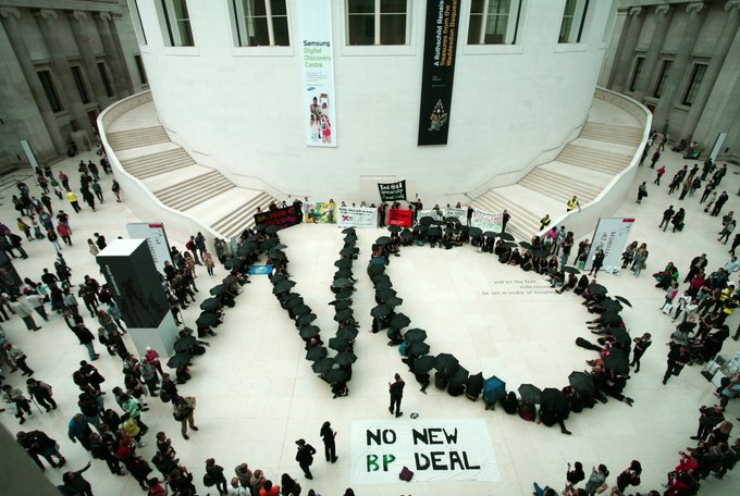 The word 'NO' at the British Museum, created by people with black umbrellas, photographed from above