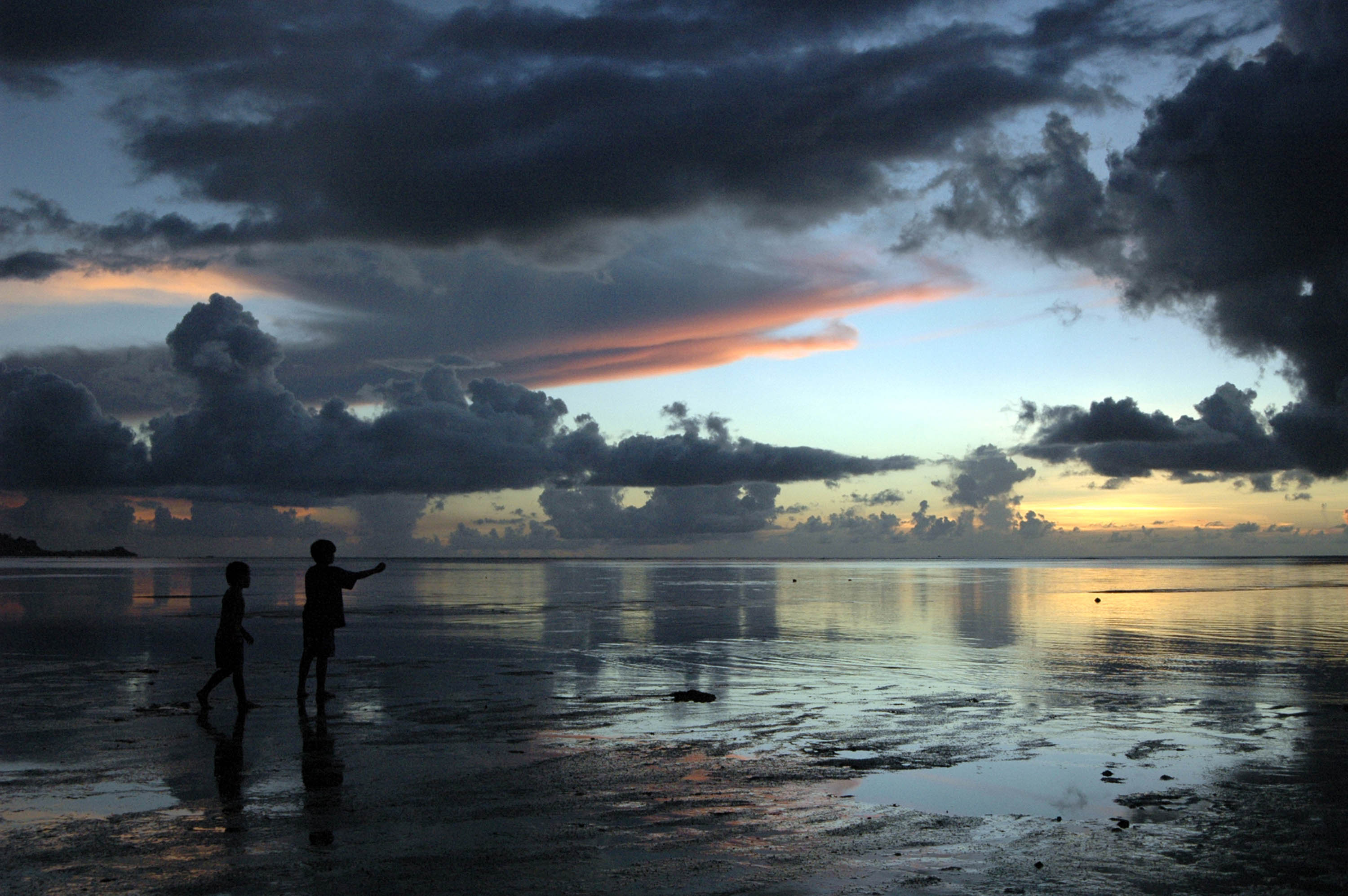 Children on beach at sunset