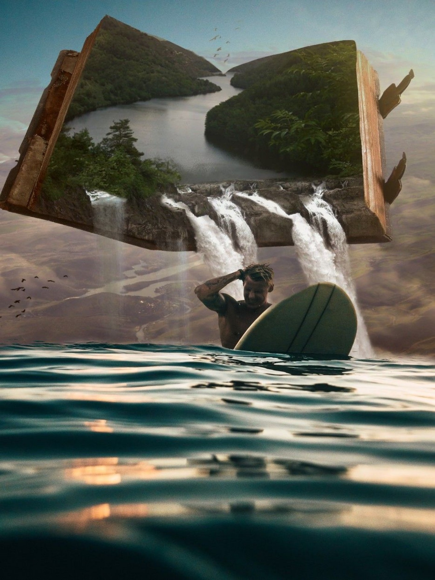A fantasy image of a male surfer relaxing in the sea. Abobe him in the sky is a book of nature, a lush river in a tropical forest, from which flow streams of water, into the sea behind him.