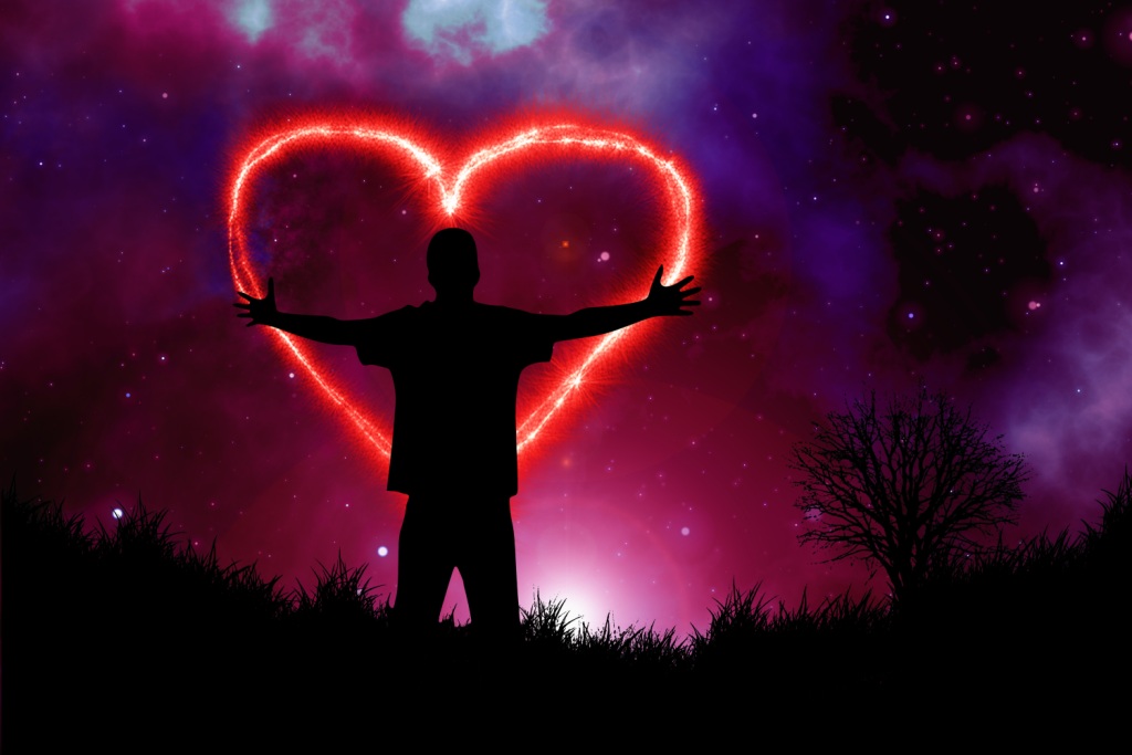 Loving the Cosmos (silhouette of man, arms outstretched, under the starry sky and a giant fiery heart)