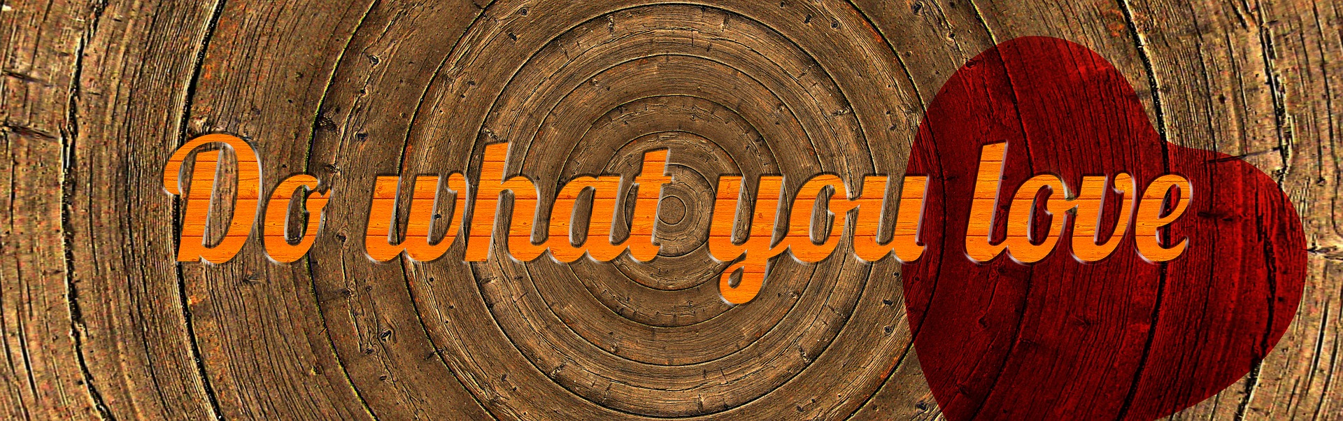 On a wooden tree disc, a message in orange letters reads 'Do what you love'. There is also a red heart under the word 'love'.