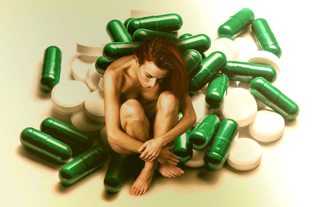 Woman sat amidst drugs