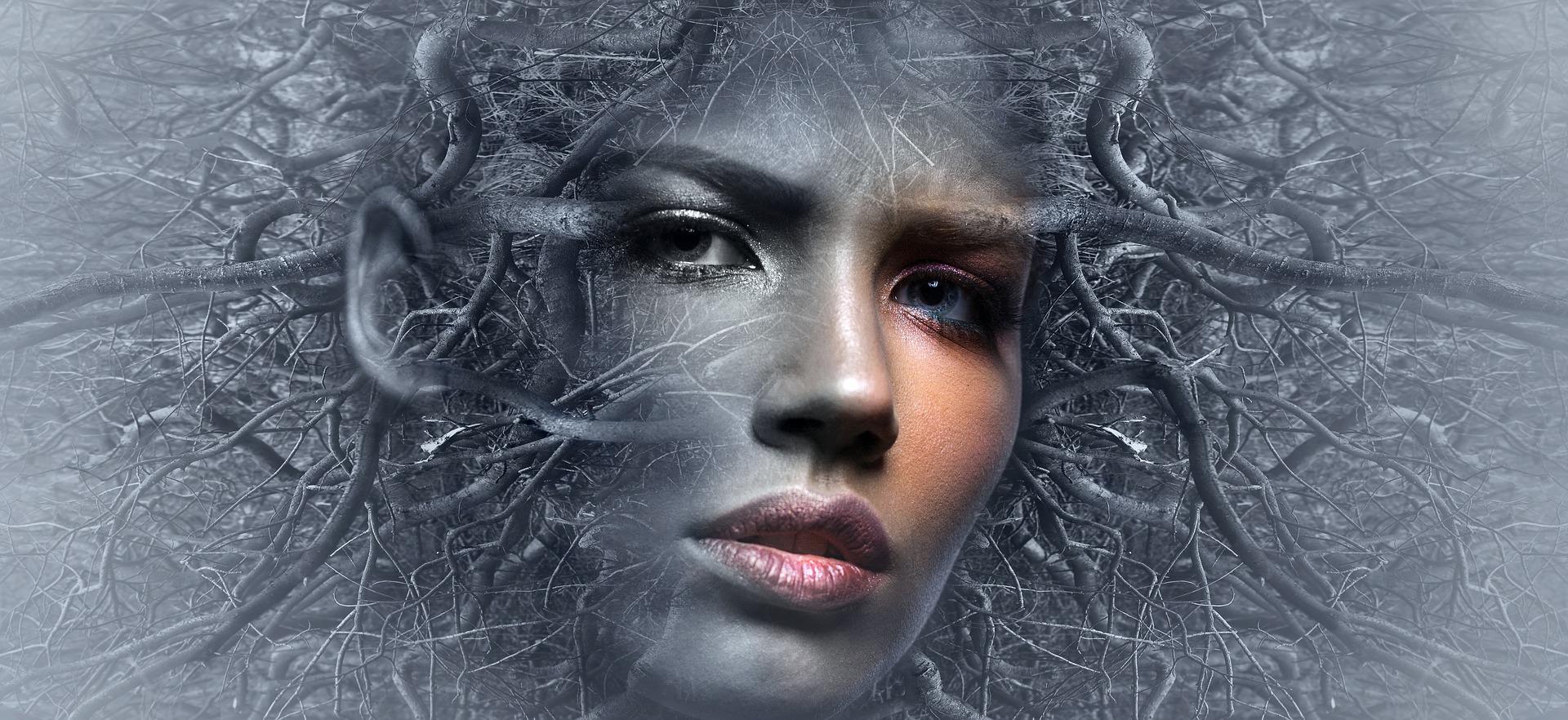 A surreal image of a serious woman's face with branches in grey appearing to be emerging from her mind