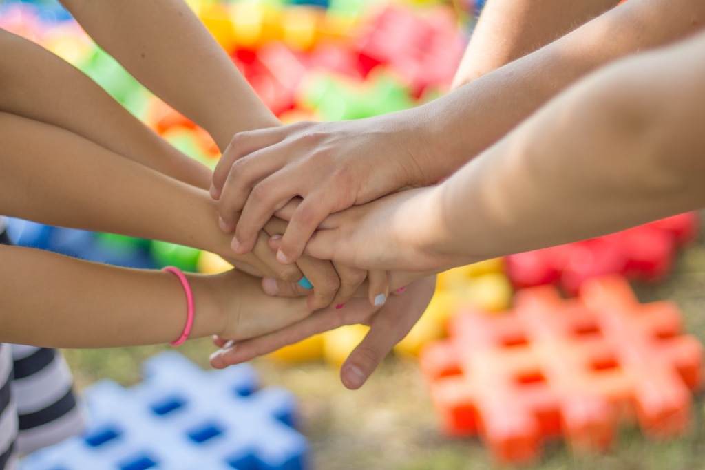 Family stacks hands in unity