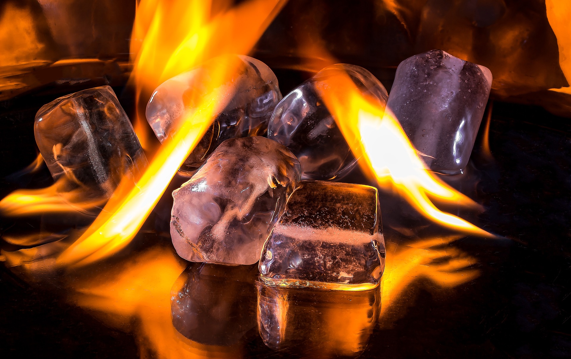 Flames of fire are melting ice cubes