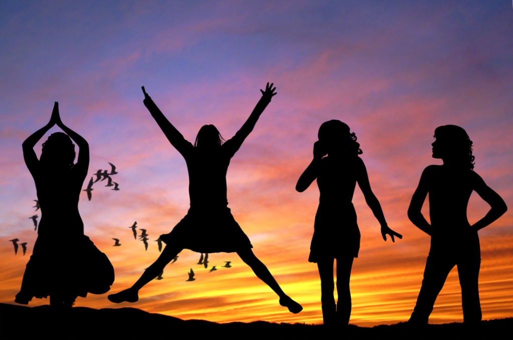 Woman jumping for joy with women