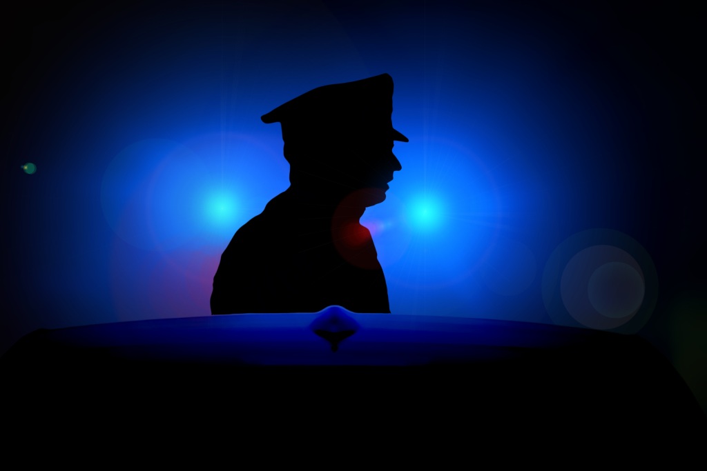 Policeman and flashing blue lights