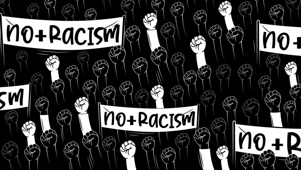 Graphic in B&W of many raised fists protesting with 'No to Racism' placards