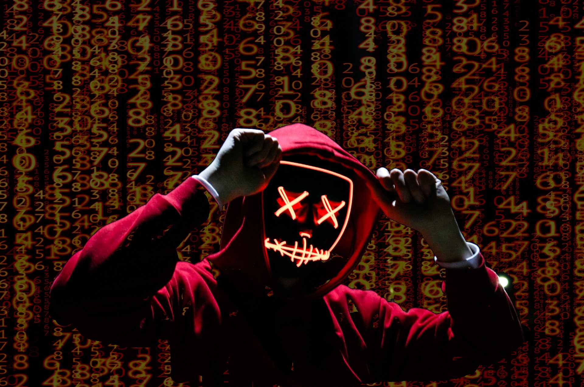 Person in red hoodie, fingers clasp top of hoodie; face has light markings, X for each eye, etc; background is digital numbers
