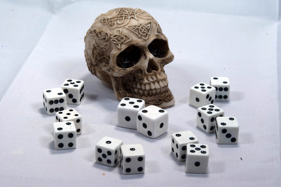 Small skull surrounded by many dice