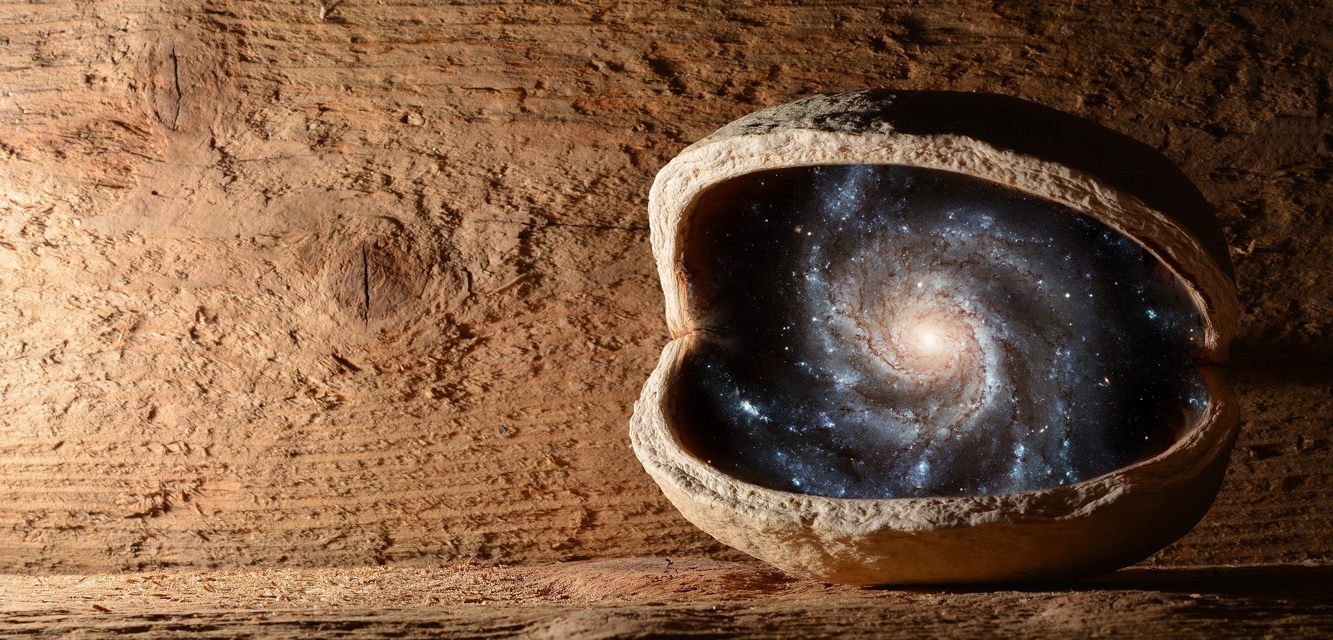 A walnut with the universe inside it. The nut sits on a wooden shelf in a wooden hut.