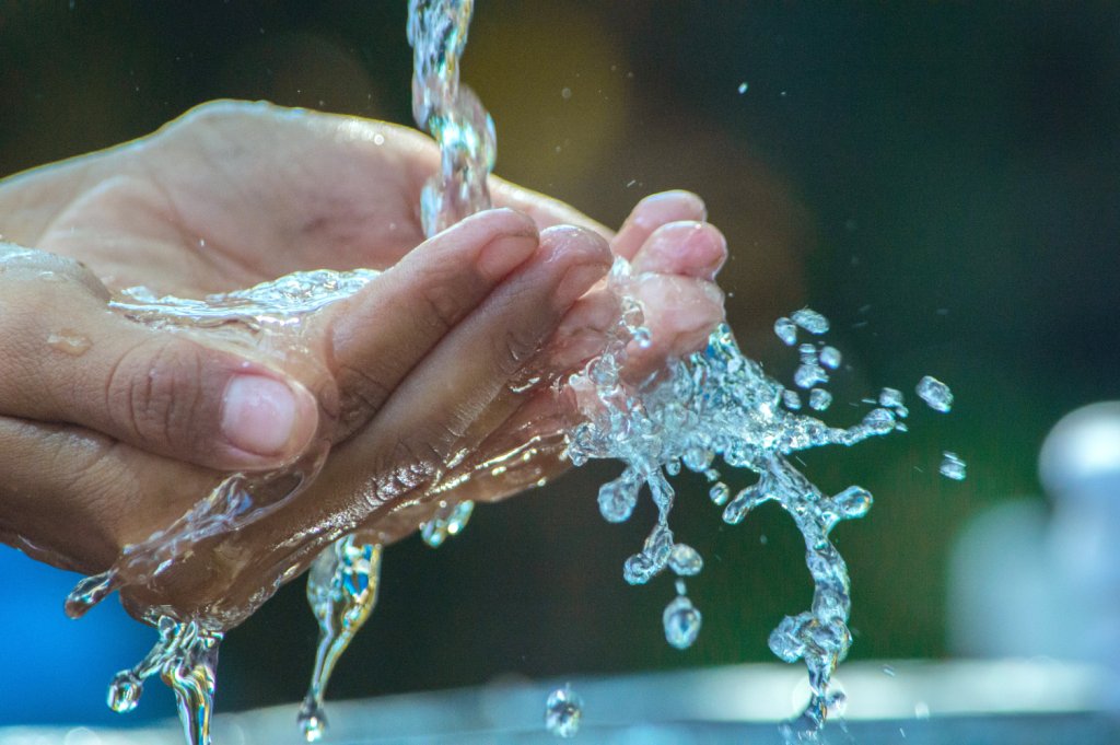 Water flowing into cupped hands