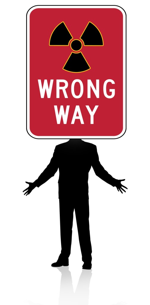 Graphic of silhouette man, arms outstretched to side, sign saying 'Wrong Way' covers his head