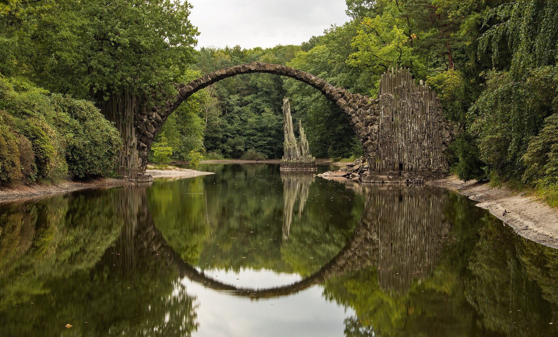 Rakotzbr&uuml;cke Devil's Bridge, Germany. The old arched high stone bridge is reflected perfectly in the water.