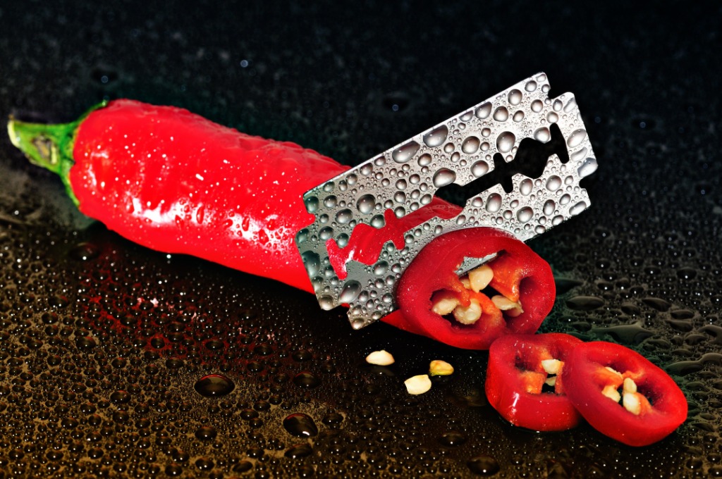Red chilli being cut up by razor